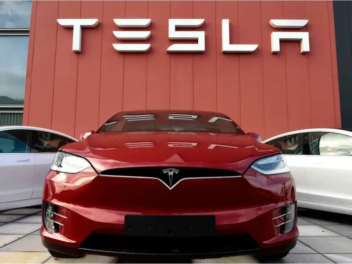 Tesla cars with company logo in the background